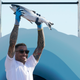 Seattle Kraken NHL hockey broadcaster JT Brown holds up a fish after he caught it Wednesday, July 21, 2021, during the Seattle Kraken’s NHL hockey expansion draft event in Seattle. The Seattle Kraken say they will make NHL history during Thursday night’s game against Winnipeg when play-by-play announcer Everett Fitzhugh and analyst JT Brown team up to form the first all-Black television broadcast crew to call an NHL game.